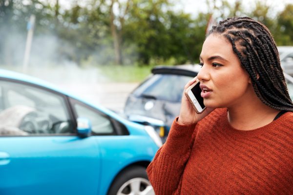 Female Motorist Involved In Car Accident Calling Insurance Company Or Recovery Service