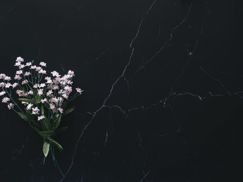 Flat lay of a floral arrangement against black marble